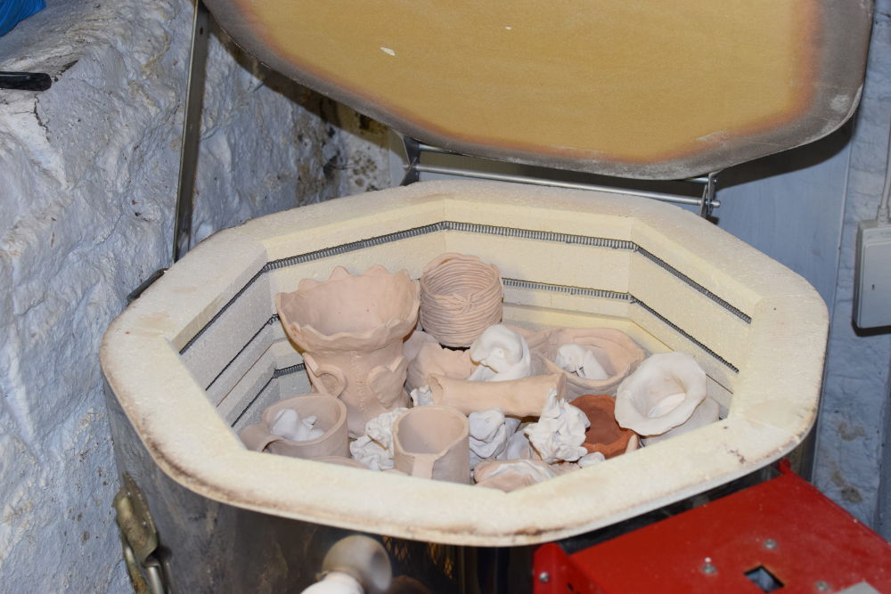 an assortment of unpainted clay items in the kiln at Trylla Bristol