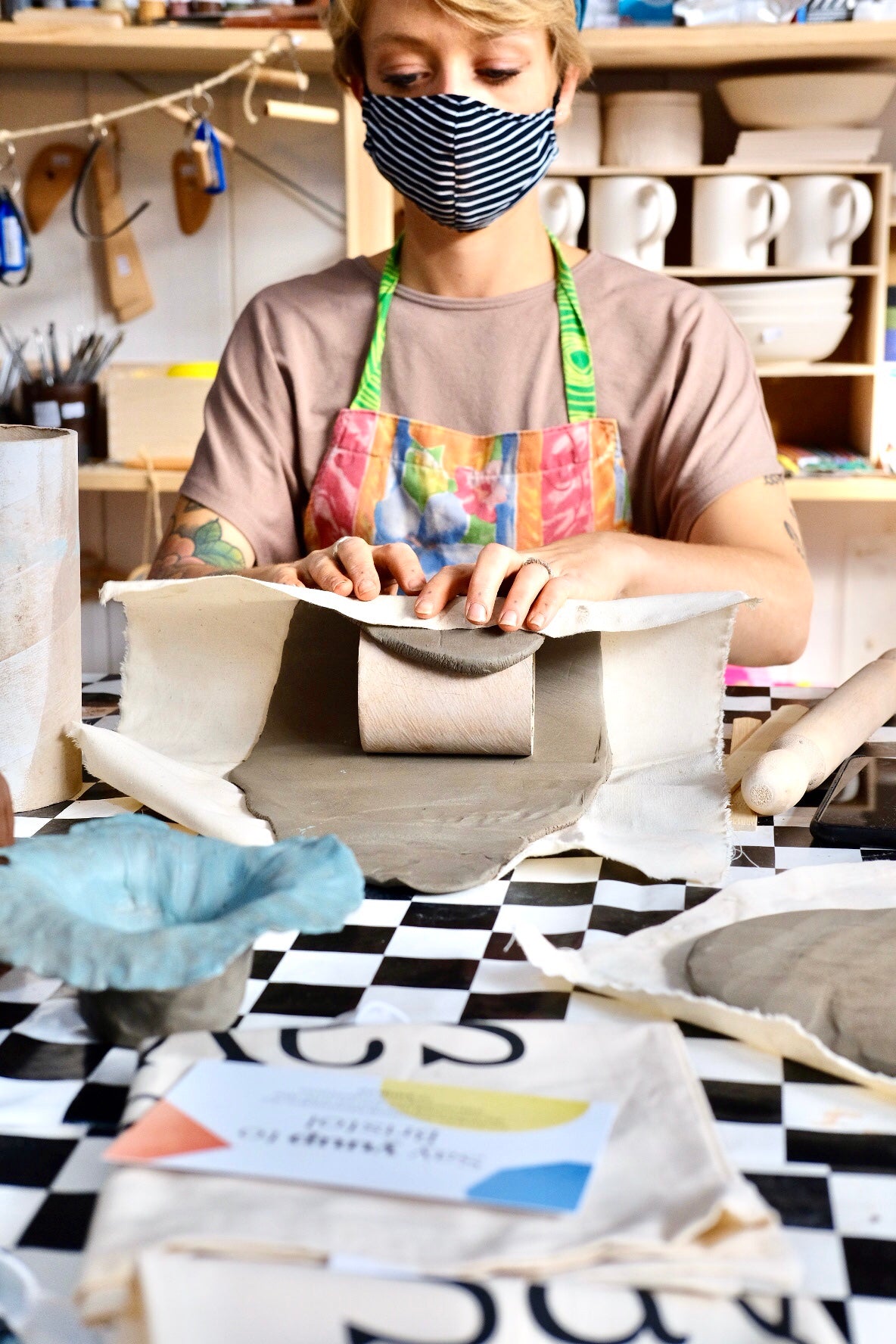 A person rolling clay over a cardboard tube at ceramics studio Trylla Bristol