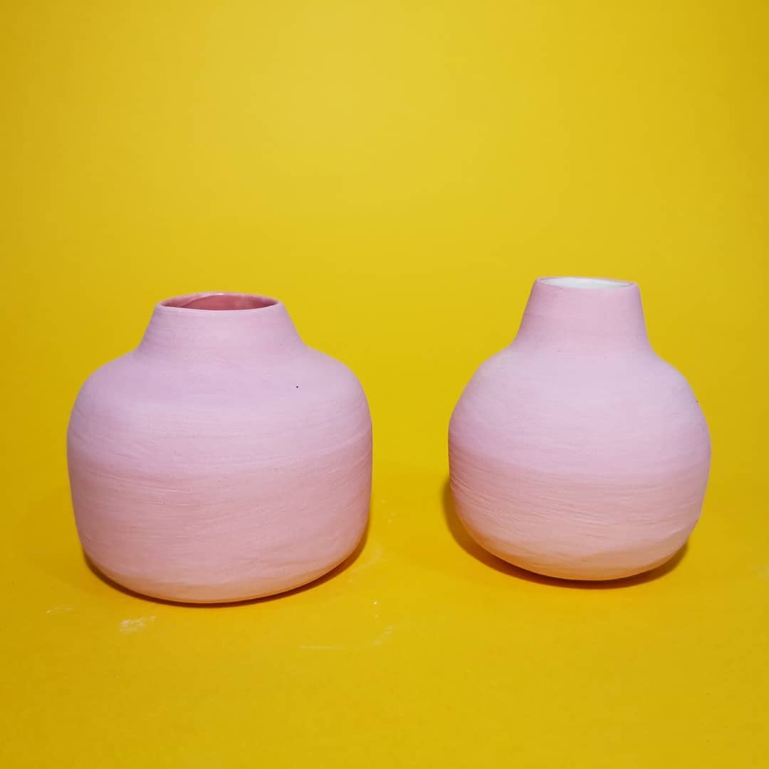 pink clay pots on yellow background