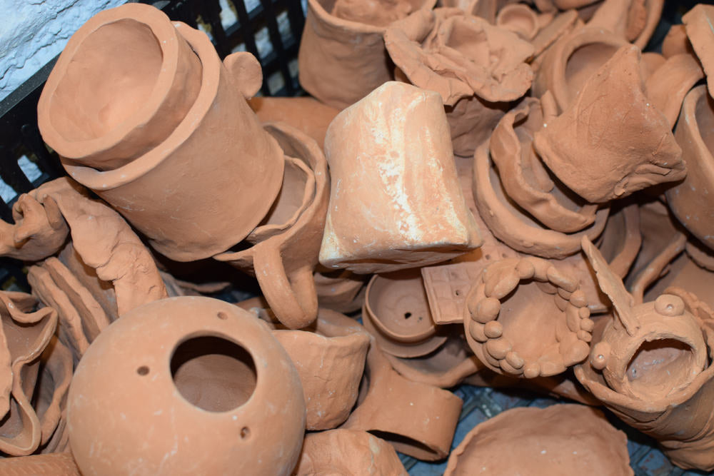 Assortment of unpainted ceramic items in a pile