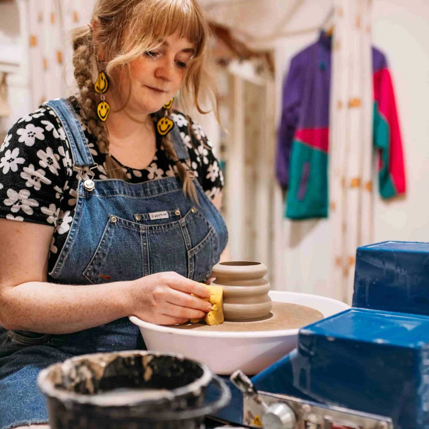 Alice, owner of ceramics studio Trylla Bristol, shaping a small vase on a pottery wheel