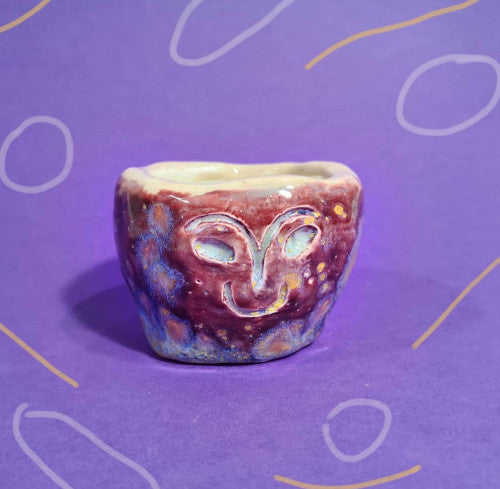 Small brown pot with a tribal-style face, made at Trylla Bristol